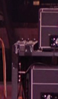 Ca. 1978, Shepperton, close-up of Big Muff Pi pedal taped on top of rig next to Hiwatt DR103W amplifier.