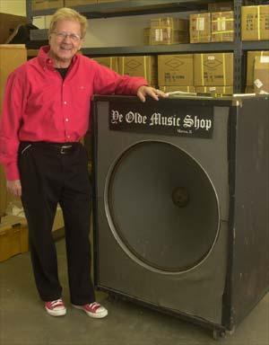 Bob Heil stands next to a speaker box with a 30-inch speaker. The sign is from Ye Olde Music Shop, his original store in Marissa, Il. Derik Holtmann/News-Democrat