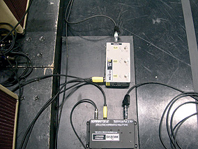 Closeup of Pete Cornish splitters: “A/B/C Box,” top, which brings in the separate amp stacks; and Piezo/Magnetic splitter, bottom, with the guitar input and piezo and magnetic signal outputs.