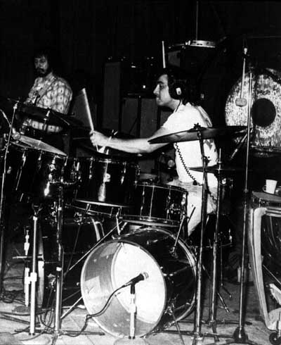 Ca. 1973, black-colored kit featuring outer row of single-headed (concert) toms. Note headphones for click-track foldback.