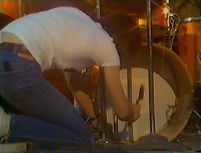 Ca. 1974, Charlton, with roadie hammering down bass drum.