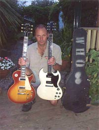 Click to view larger version. Clint Nurse, with Les Paul Deluxe and Gibson SG Special, prior to auction.