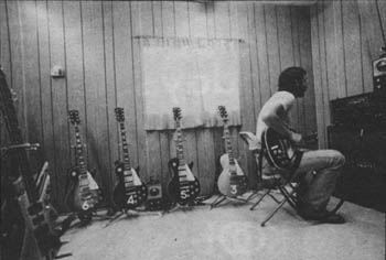 Click to view larger version. October 1976, backstage in Oakland, Calif., tuning up with a Conn strobe tuner. From left to right, nos. 6 (Cherry Sunburst), 4 (Wine Red), 5 (Wine Red), 3 (Gold Top), 1 (Wine Red).